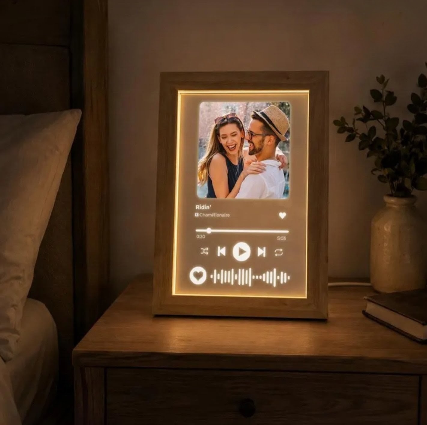 Personalised music photo acrylic plaque in a wooden LED frame on a bedside table