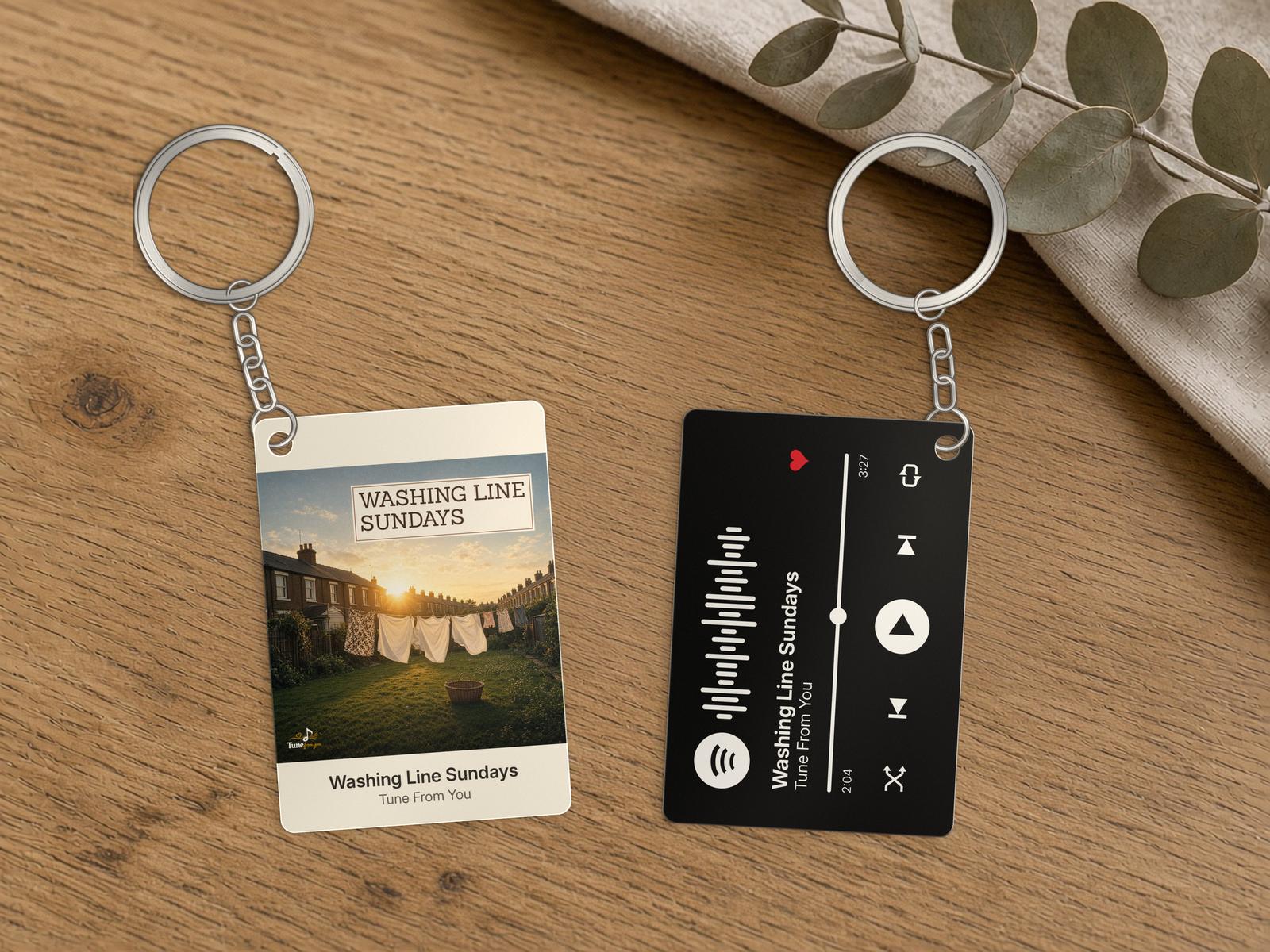 Two metal song keyrings: one shows the Washing Line Sundays cover, the other a black music-player back with a Spotify code